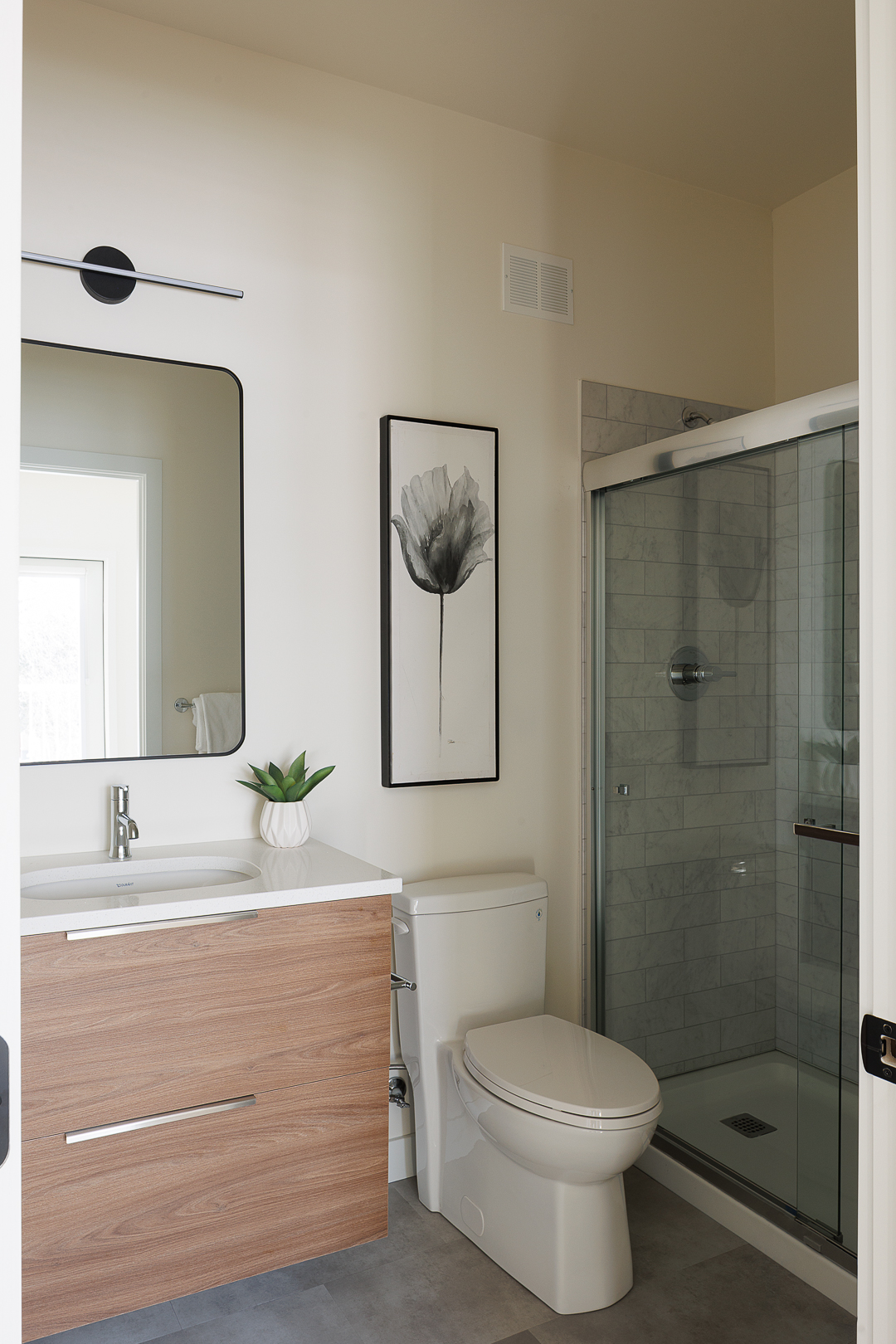 Full bathroom with walk-in shower and marble tile